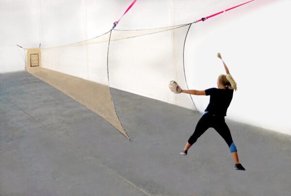 A woman is throwing a ball in the air