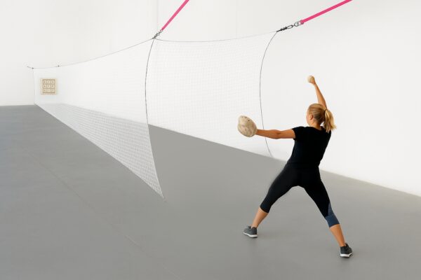 A woman is throwing a ball in the air